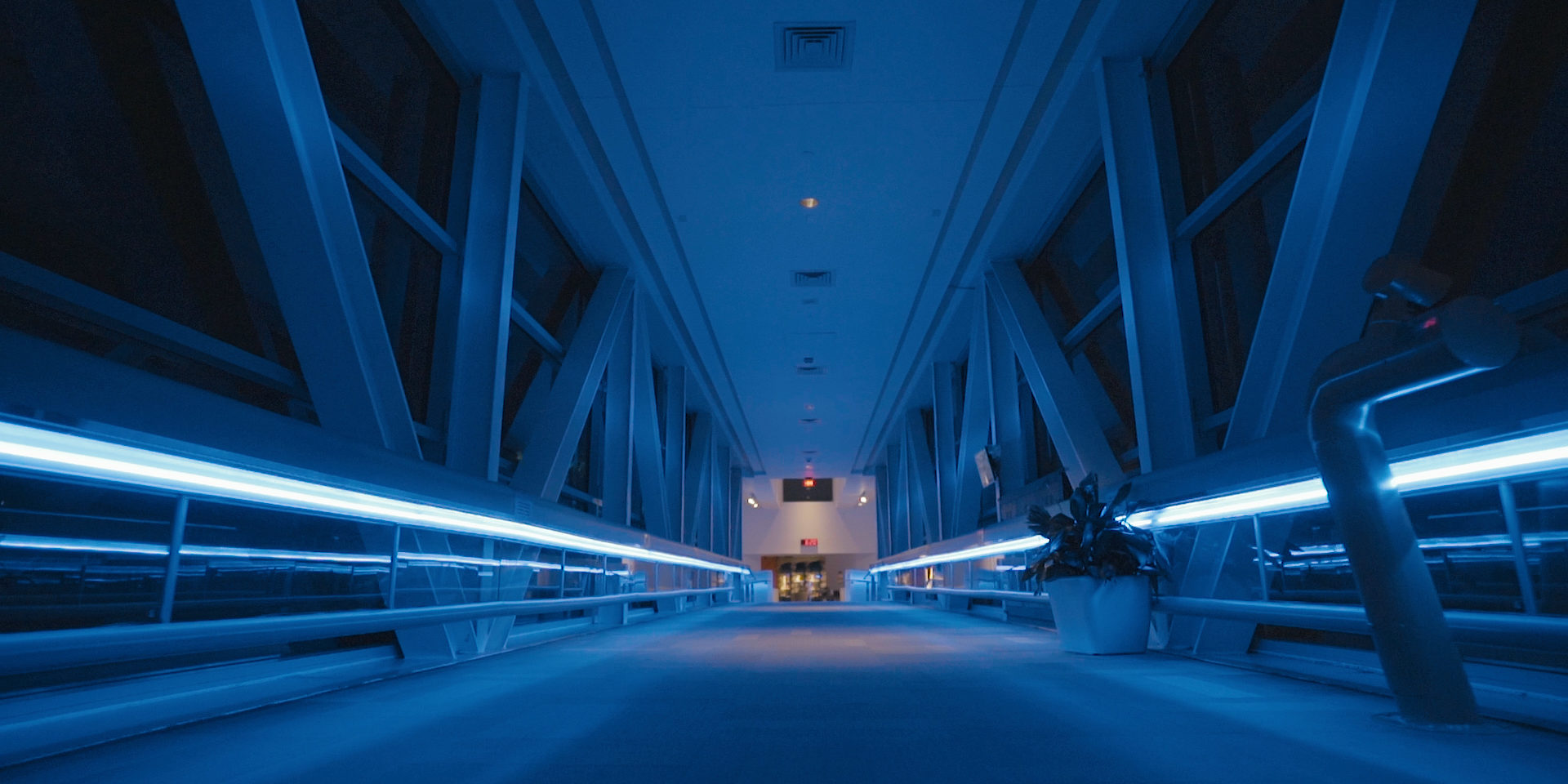 A blue lit skyway from the Planetarium to the St. Louis Science Center